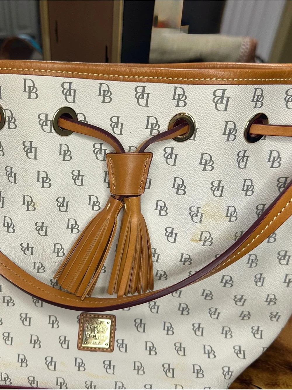 Dooney & Bourke White and Tan Tassel Drawstring Tote with DB Monogram